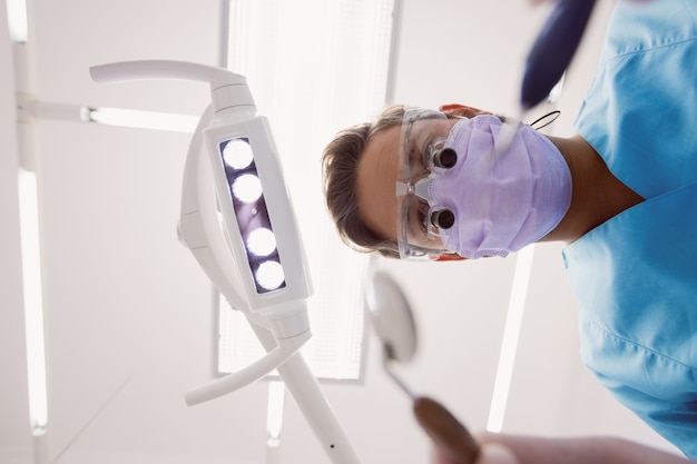 Dentista segurando ferramentas dentárias