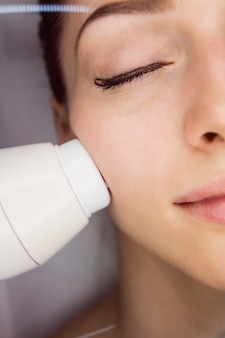 Dermatologista dando massagem facial através de elevação sônica