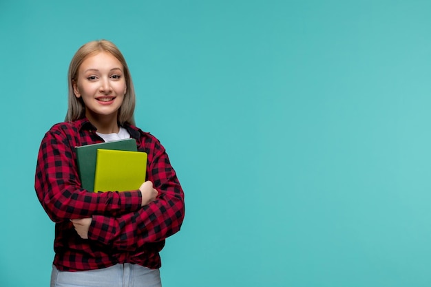 Dia dos estudantes internacionais menina bonita loira de camisa vermelha sorrindo e segurando livros