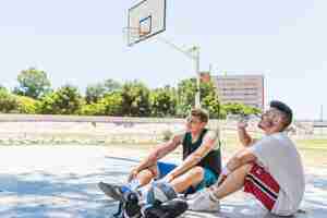 Foto grátis dois, jogador basquetebol, relaxante, em, ao ar livre, corte