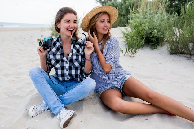 Duas amigas felizes se divertindo na praia