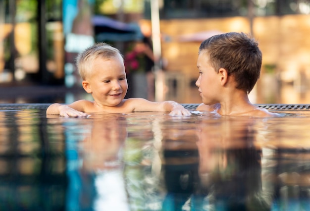 Duas crianças aproveitando o dia na piscina