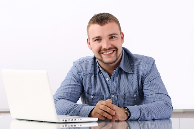 Foto grátis empresário bonito no seu local de trabalho