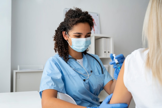 Foto grátis enfermeira na clínica praticando medicina