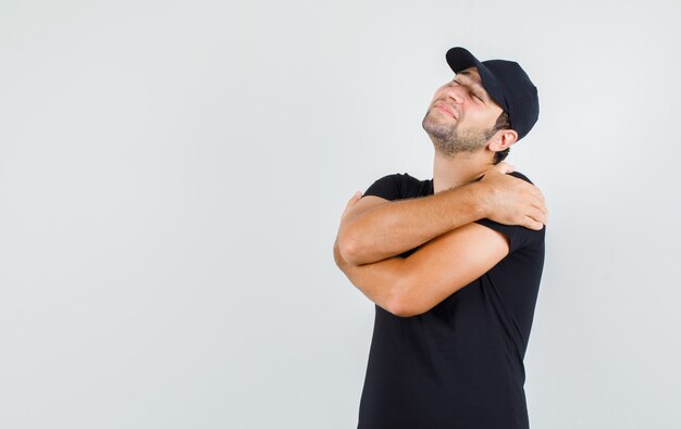 Entregador se abraçando em uma camiseta preta