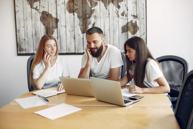 Equipe jovem trabalhando juntos e use o laptop