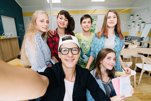 Estudantes alegres olhando a câmera ao posar