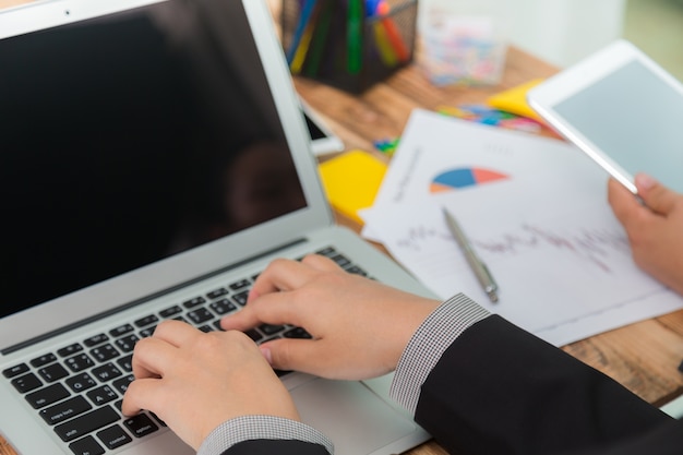 Executivos com um laptop e um tablet visto do lado