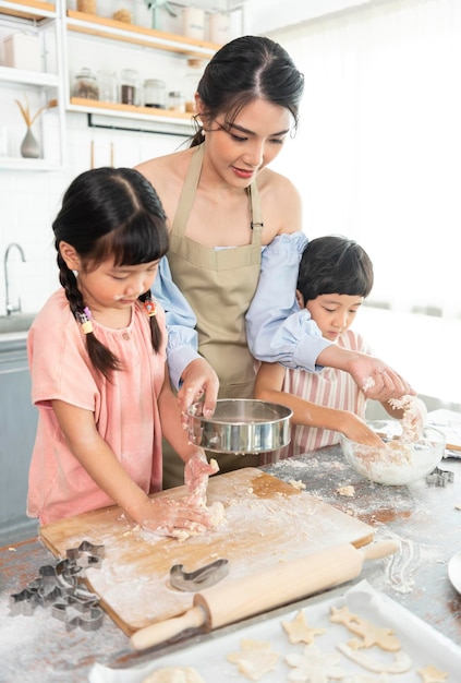 Família asiática feliz fazendo comida na cozinha em casa Aproveite a atividade familiar juntos