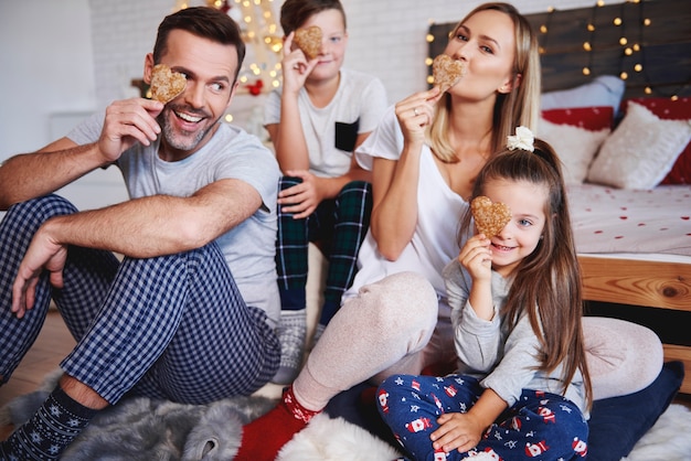 Família brincalhona comemorando o Natal na cama