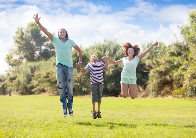 família com adolescente pulando no parque