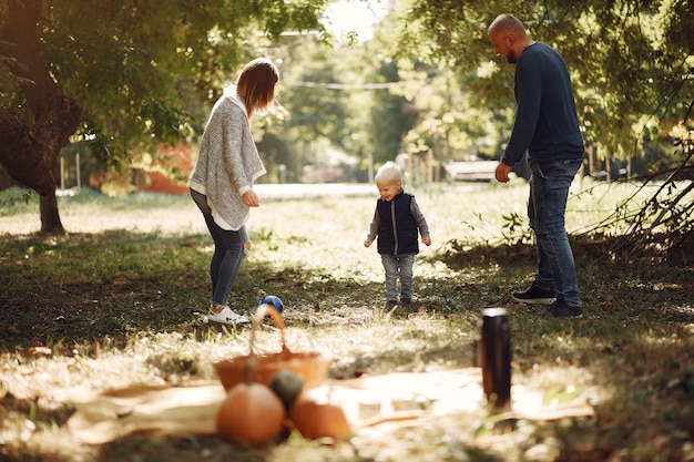 Família com filho pequeno em um parque de outono