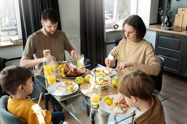 Foto grátis família cristã de tiro médio comendo juntos