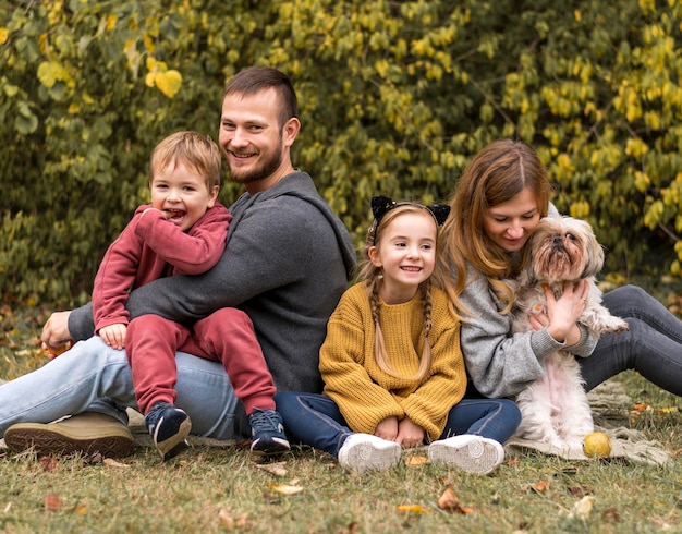 Família feliz com cachorro ao ar livre