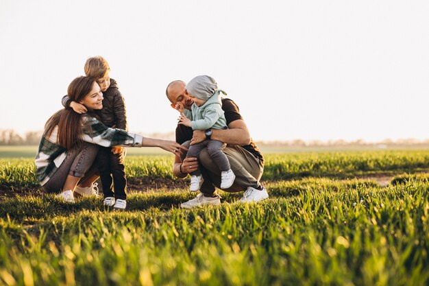 Foto grátis família feliz se divertindo no campo na sunset