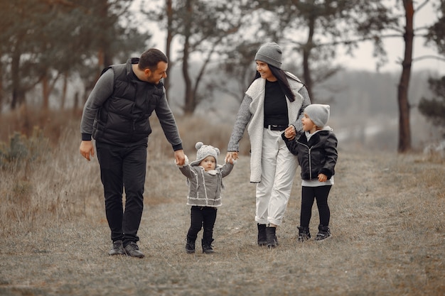 Família fofa brincando em uma floresta de primavera