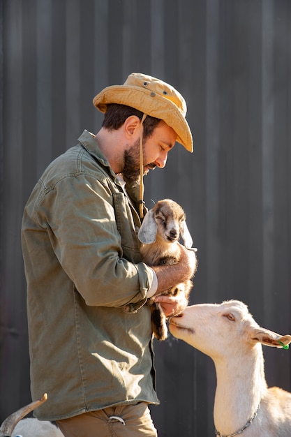 Fazendeiro cuidando de suas cabras na fazenda
