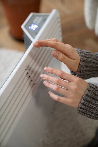 Fechar a pessoa perto do aquecedor