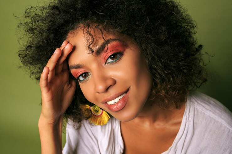 Foto grátis feche o retrato da mulher africana com colorido brilhante; maquiagem posando