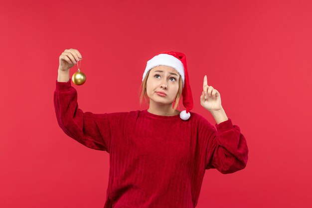 Fêmea normal de vista frontal com brinquedo de árvore de natal, feriado de natal vermelho