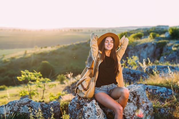 Feminino caminhante relaxante na rocha