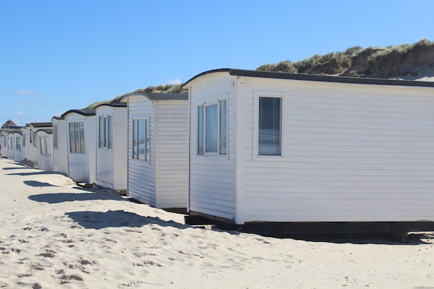 Fileira de cabanas brancas na praia de Lokken, Dinamarca