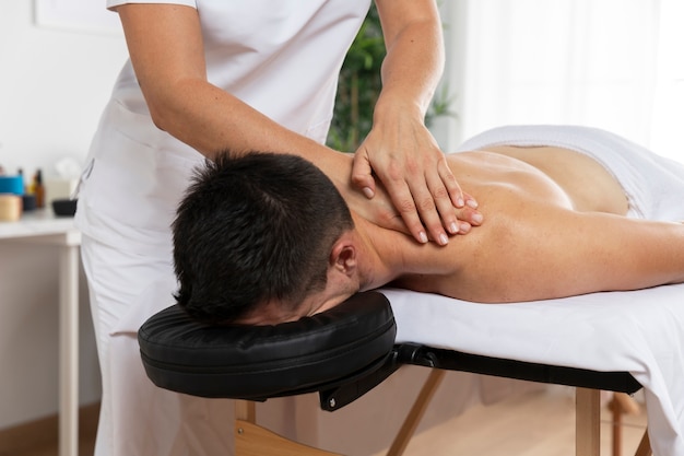 Fisioterapeuta massageando paciente no consultório