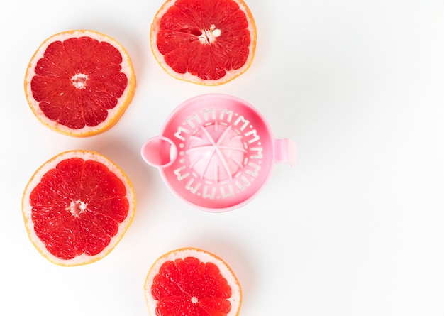 Foto grátis flat lay juicer e grapefruit em metades