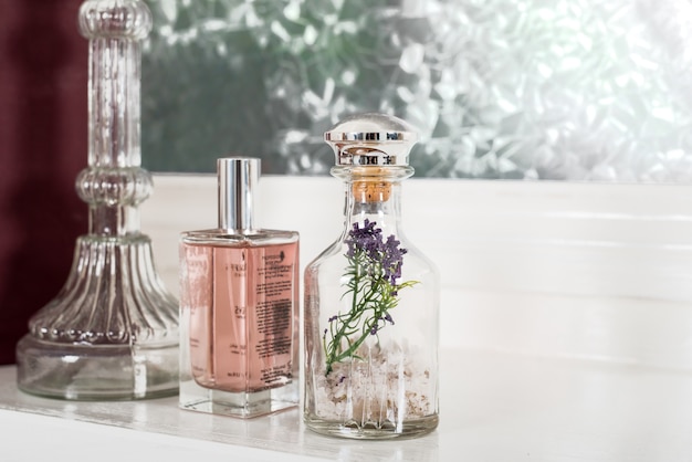 Foto de close de frascos de vidro com formatos lindos cheios de perfume