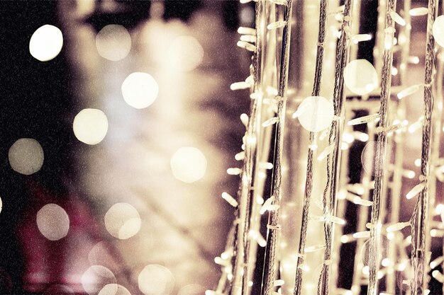 Foto desfocada do fundo da rua na noite de neve com luzes de natal