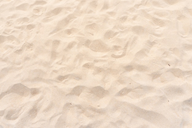 Foto do close up textura amarela da areia da praia como pano de fundo