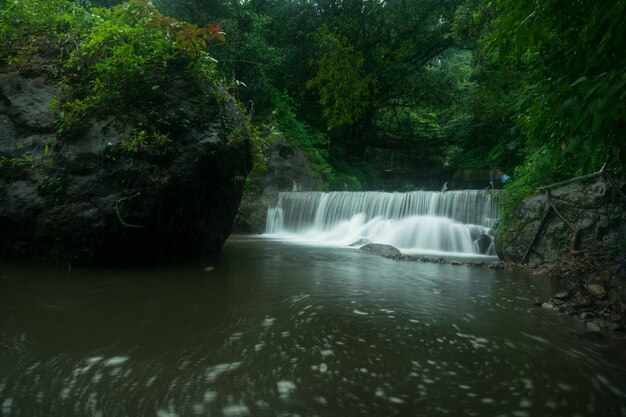 Foto incrível de uma pequena cachoeira cercada por uma bela natureza