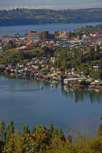 Foto vertical de edifícios na costa perto do mar com barcos