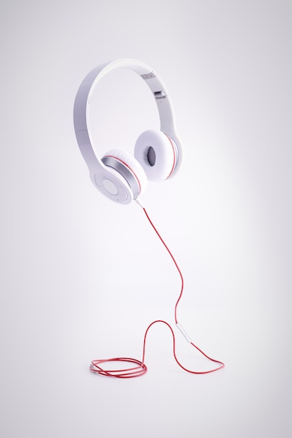 Foto grátis foto vertical de fones de ouvido brancos com um cabo vermelho