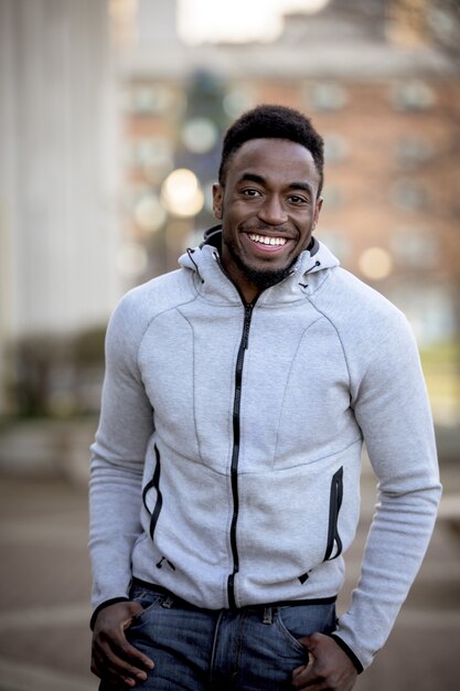 Foto vertical de um homem afro-americano atraente posando e sorrindo