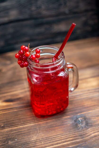 Frente com suco de cranberry fresco dentro da lata no escuro da mesa.