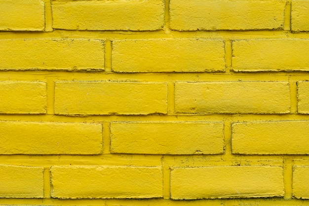 Fundo abstrato amarelo da parede de tijolo