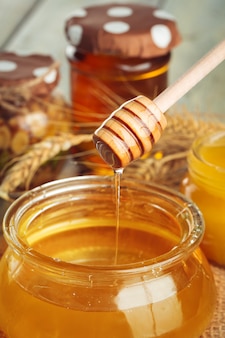 Fundo de mel. doce mel em frasco de vidro com fundo de madeira.