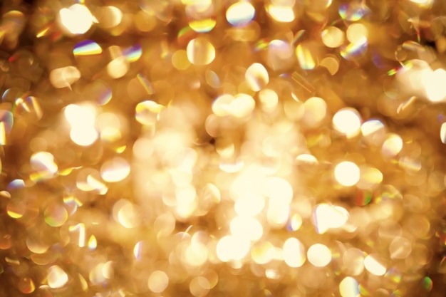 Fundo de natal. fundo desfocado de glitter abstrato férias douradas com estrelas piscando. boke borrado