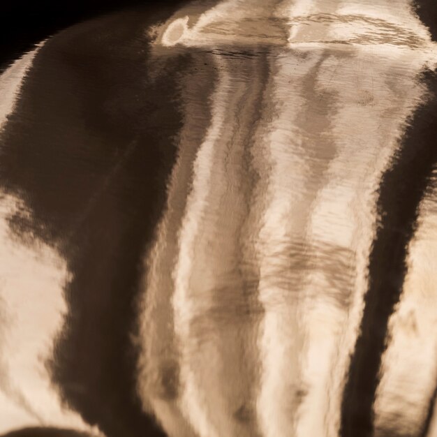 Foto grátis fundo de textura oleosa de ouro com sombras