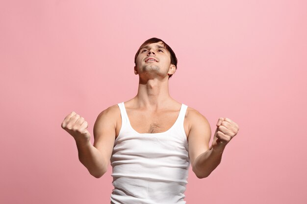 Ganhar sucesso homem feliz em êxtase comemorando ser um vencedor. Imagem energética dinâmica do modelo masculino