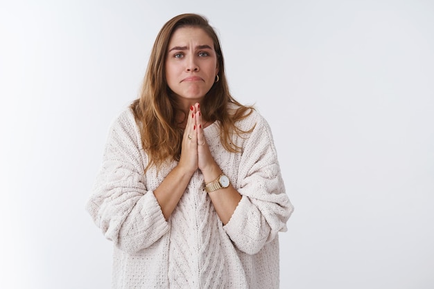 Garota agindo de forma boba, miserável, suplicando, pressionando as palmas das mãos juntas, reze, franzindo os lábios, pedindo por favor, ajude a emprestar dinheiro implorando por favor lookg fofo pobre gatinho