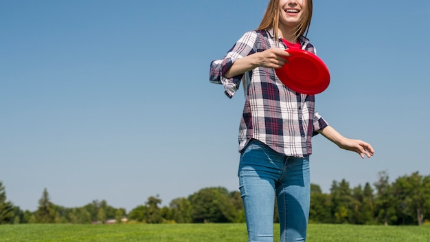 Garota de vista frontal brincando com seu frisbee