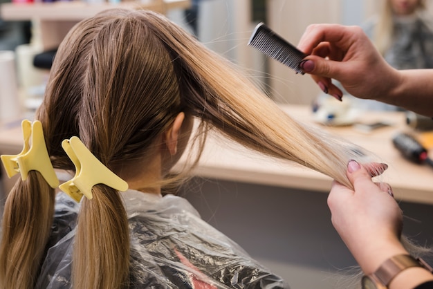 Garota loira fazendo o cabelo dela