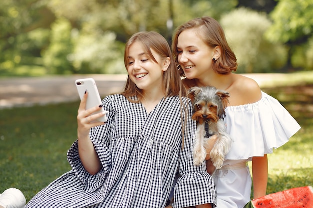 garotas bonitas em um parque brincando com cachorro