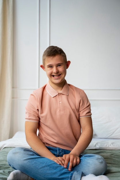 Foto grátis garoto sorridente de vista frontal com síndrome de down