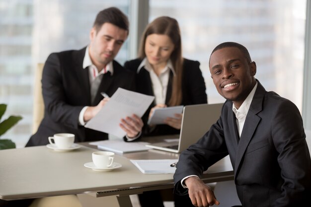 Gerentes de RH lendo currículo de candidato a emprego negro