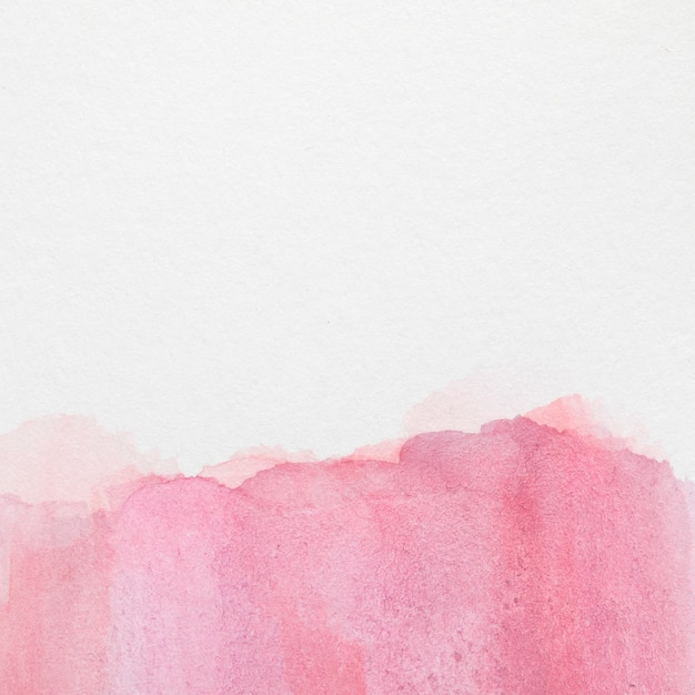 Gradiente rosa pintada à mão mancha na superfície branca