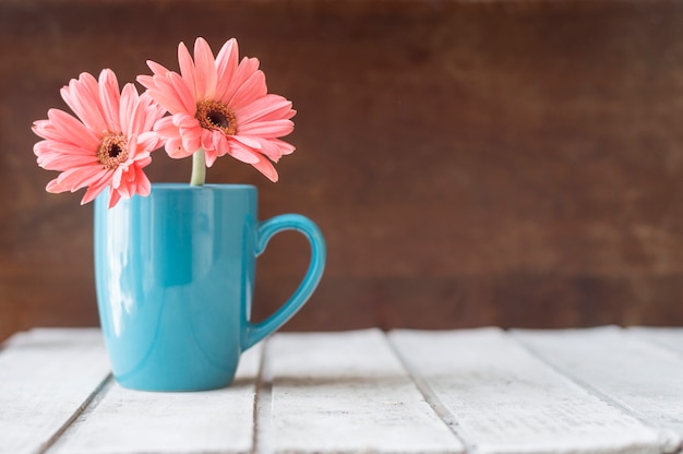 Grande fundo com a caneca azul decorativa e flores