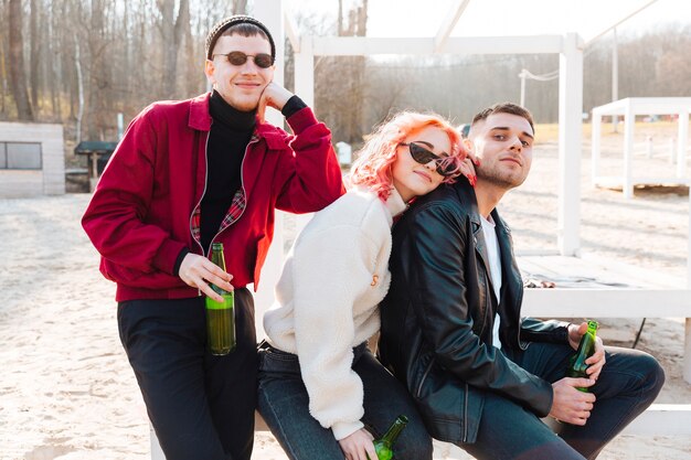 Grupo de amigos felizes com cerveja a passar tempo juntos